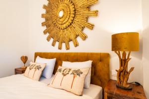 a bedroom with a bed with a large mirror on the wall at Sol Amarillo in Mijas Costa +8 photos