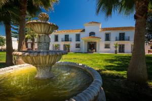 a large fountain in front of a house at Sol Amarillo in Mijas Costa