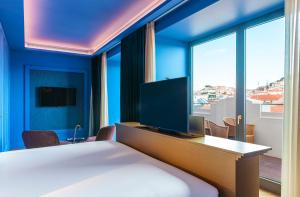 TV a/nebo společenská místnost v ubytování Art Legacy Hotel Baixa-Chiado