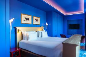 Postel nebo postele na pokoji v ubytování Art Legacy Hotel Baixa-Chiado