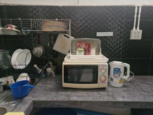 a microwave sitting on top of a kitchen counter at Katika Home 2 in Ban Khlong Haeng
