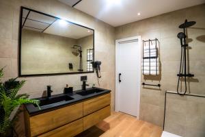 a bathroom with a sink and a large mirror at Novaotel Malaga in Málaga +55 photos