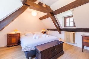 a bedroom with a large bed in a attic at Terrasse charme & nature en coeur de Lannion in Lannion