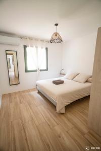 a white bedroom with a large bed and a window at La Casa Garriga - Pont du Gard - Nîmes in Lédenon +29 photos