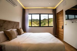 a bedroom with a large bed and a window at Novaotel Malaga in Málaga