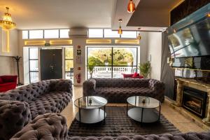 a living room with couches and a fireplace at Novaotel Malaga in Málaga
