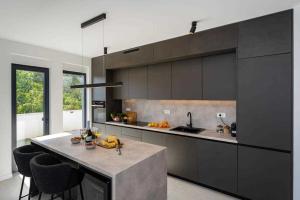 a kitchen with a island in the middle of a room at Villa Silente with pool in a quit area in Seline