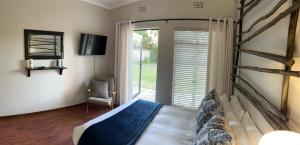 a bedroom with a bed and a large window at 28 La Rochelle in Kimberley