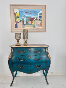 a blue dresser with a picture on the wall at Villa Verde Sidi Bou Said in Sidi Bou Saïd +42 photos
