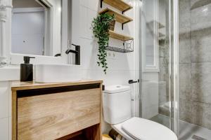 a bathroom with a toilet and a sink and a shower at Gros Beach Heaven -Prime Location in Donostia-San Sebastián +19 photos