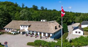 an aerial view of a house with a red flag at Bromølle Kro in Jyderup