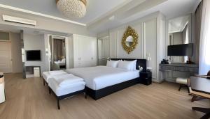a bedroom with a large white bed and a television at simge pansiyon in Istanbul