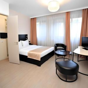 a hotel room with a bed and tables and chairs at simge pansiyon in Istanbul +13 photos