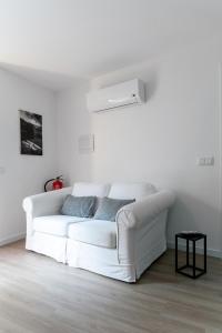 a white couch in a white living room at Casinha da Avó Ana in Sever do Vouga +12 photos