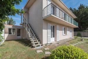 a house with a staircase on the side of it at La Saline - Wifi - Parking - Jardin in Bourgneuf-en-Retz