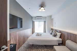 Ένα ή περισσότερα κρεβάτια σε δωμάτιο στο Apartment Hotel 11 Osaka Dome