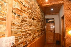 a brick wall in a room with a hallway at Blissful Lodge in Banjār