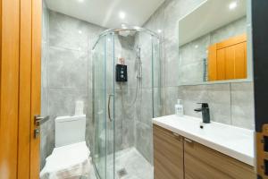 a bathroom with a shower with a toilet and a sink at Bloomsaway Seafront Two Bedroom BN112SHP03 in Brighton & Hove