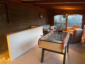 a living room with a foosball table at Chalet les brimbelles in Le Tholy