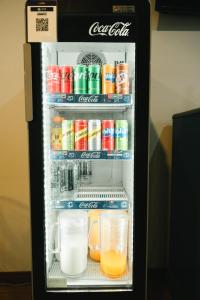an open refrigerator filled with drinks and drinks at The Ten Hotel Thippanate in Chiang Mai