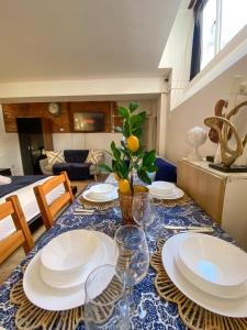 a dining room table with plates and glasses on it at City Centre Beautiful & Cosy Studio Apartment in Manchester +9 photos