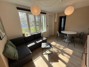 a living room with a couch and a table at Blanchette in Criel-sur-Mer