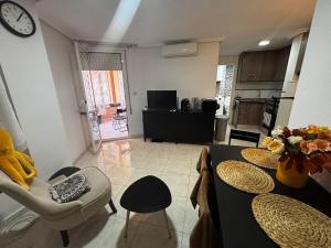 sala de estar con sillas y reloj en la pared en Calle Galeon, en Torrevieja