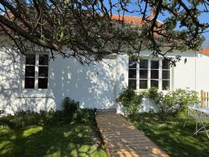 a white house with a wooden walkway in front of it at Blanchette in Criel-sur-Mer