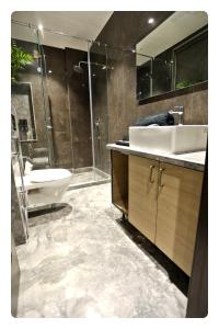 a bathroom with a sink and a toilet and a shower at KRYC Luxury Living near Indraprastha Apollo Hospital in New Delhi +42 photos