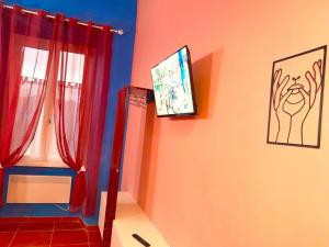 a bathroom with red curtains and a window at LA CASA DI CARTA red in Fiuggi