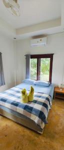 a bedroom with a bed with yellow shoes on it at Secret Thai Peace No1 in Thongsala