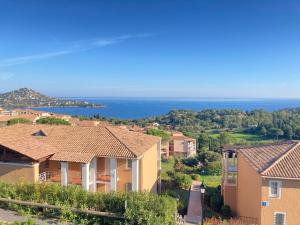 a view of a village with houses and the ocean at Cap Estérel by Actisource in Agay - Saint Raphael +21 photos