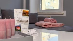 a room with a couch with a blanket on a table at Na Mijance by LibertaRent in Wałbrzych