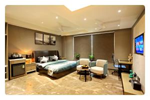 a bedroom with a bed and a tv in it at KRYC Luxury Living near Indraprastha Apollo Hospital in New Delhi