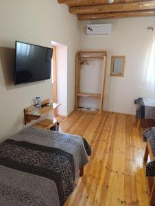 a room with two beds and a flat screen tv at Old Town Hotel in Khiva