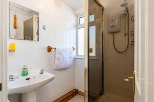 a bathroom with a sink and a shower at Casa Sirena Apartment in Fistral, Newquay in Newquay +19 photos