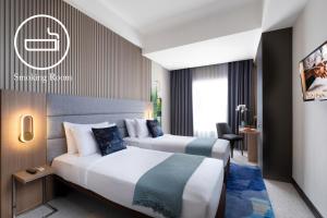 Letto o letti in una camera di Oakwood Merdeka Bandung