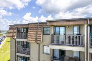 an apartment building with balconies and tables at Southwinds G16 condo in Atlantic Beach
