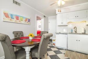 a kitchen and dining room with a table and chairs at Southwinds G16 condo in Atlantic Beach +14 photos