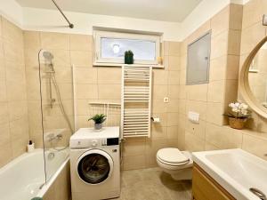 a bathroom with a washing machine and a toilet at Akácfa Apartment by Chivi II FreeParking in Budapest +14 photos