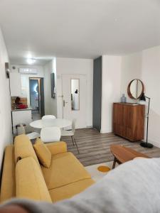 a living room with a couch and a table at SUPERBE STUDiO LE PANIER NO EXTRA FEES historic district in Marseille