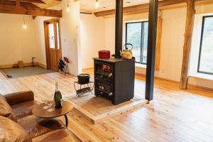 a living room with a wood stove in it at GOMYO LIFE Hotel in Higashikagawa