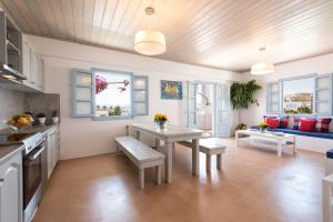 Una cocina y una sala de estar con una mesa y un sofá. en Menta I in the heart of Naousafree parkingParos, en Naousa
