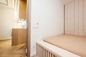 a small room with a bed and a closet at Golden Dunes Apartment in Palanga