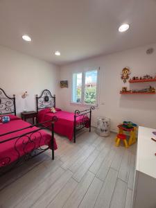 a bedroom with two beds and a window at Sunrise Home in Porto Ottiolu