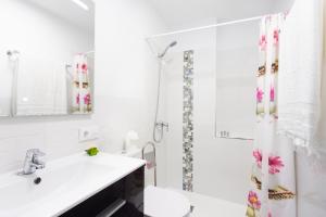 a bathroom with a sink and a toilet and a shower at Santana Sunshine by Sunkeyrents in Santiago del Teide +18 photos