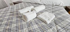 a bed with white pillows on top of it at Habitaciones en Chalet 1º linea de playa in Cullera