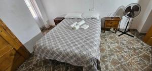 a bedroom with a bed with two pillows on it at Habitaciones en Chalet 1º linea de playa in Cullera