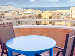 a blue table and chairs on a balcony with a view at Garrucha Blue Horizon in Garrucha +23 photos
