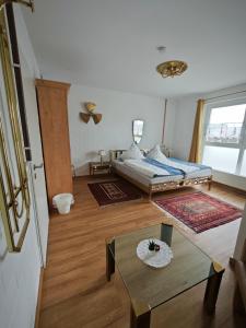 a room with a bed and a table in it at MiNe Hotel in Weilerswist +25 photos